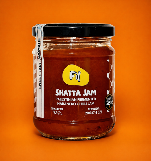 Jar of Shatta Jam with a yellow label on an orange background